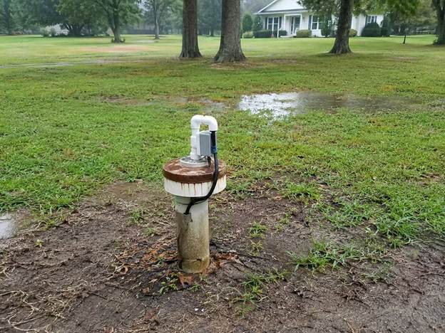 Private well surrounded by wet ground after heavy rain in Central Virginia